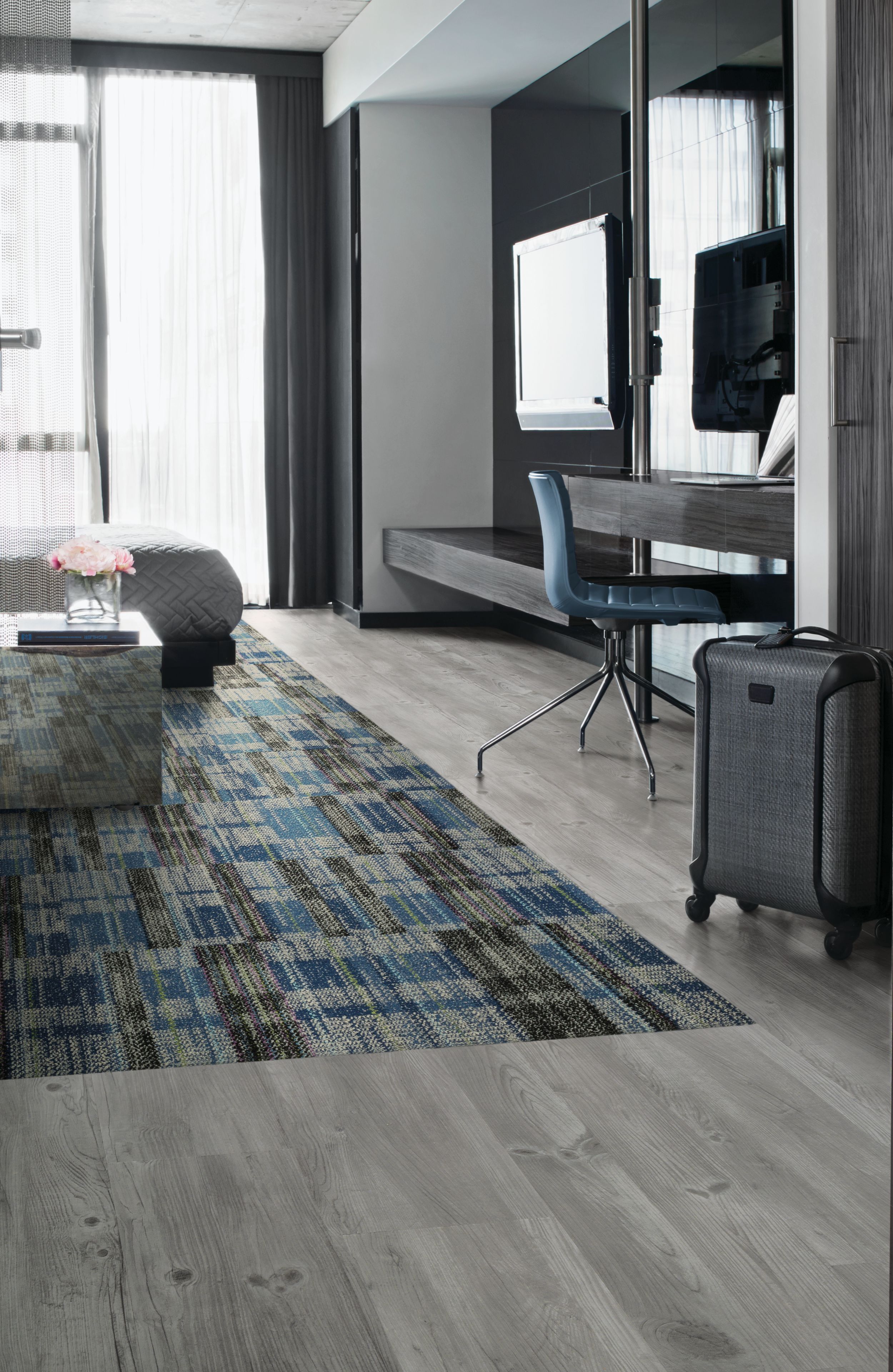 Interface SummerHouse Brights carpet tile as inset rug with Natural Woodgrains LVT in hotel guest room image number 11